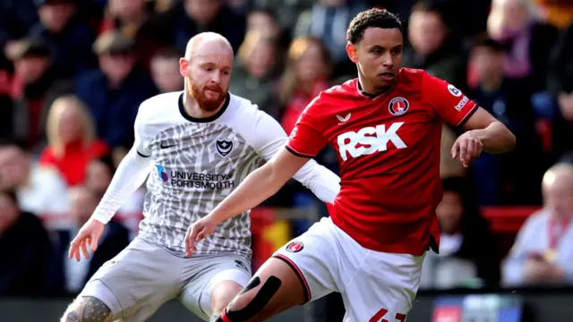 Charlton and Portsmouth players challenge for the ball