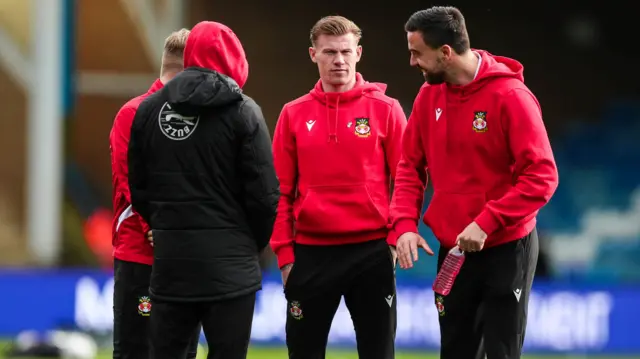 Wrexham players assess the pitch at Gillingham