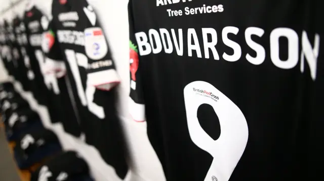 Bolton shirts hung up in dressing room