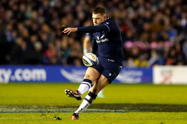 Finn Russell kicks at goal