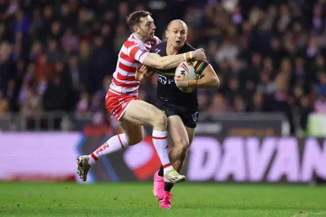 Wigan's Jake Wardle tackles Dylan Edwards