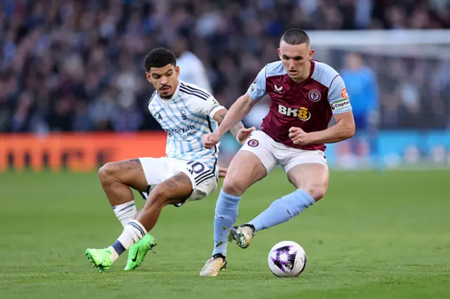 John McGinn of Aston Villa runs with the ball whilst under pressure from Morgan Gibbs-White