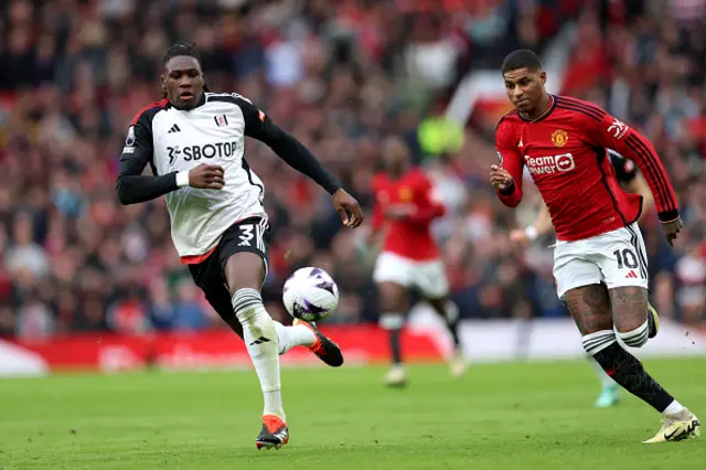 Calvin Bassey and Marcus Rashford in action