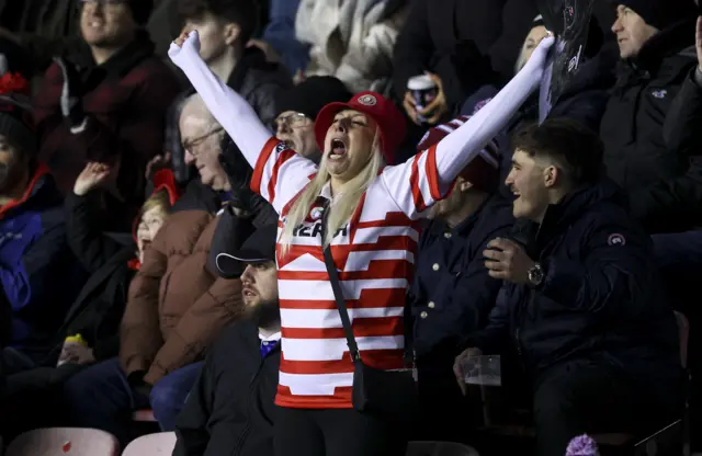 A Wigan fan celebrates