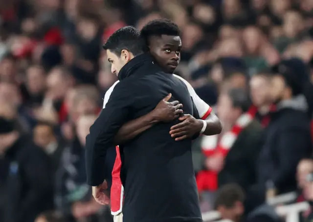 Saka hugs Arteta on the sideline