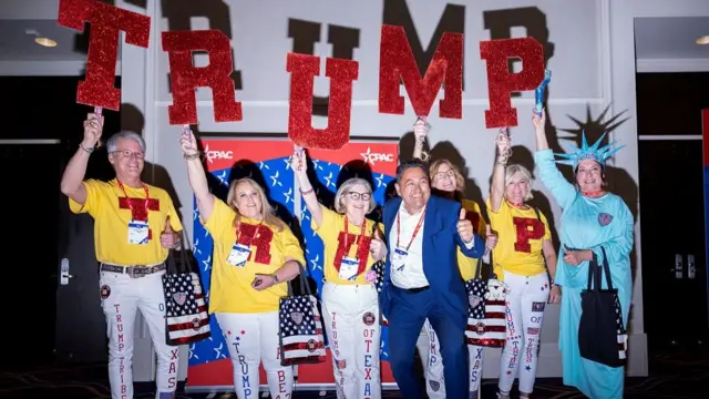 A group of Trump supporters hold up signs at the Conservative Political Action Conference (CPAC) annual meeting in National Harbor, Maryland, U.S., February 22, 2024.