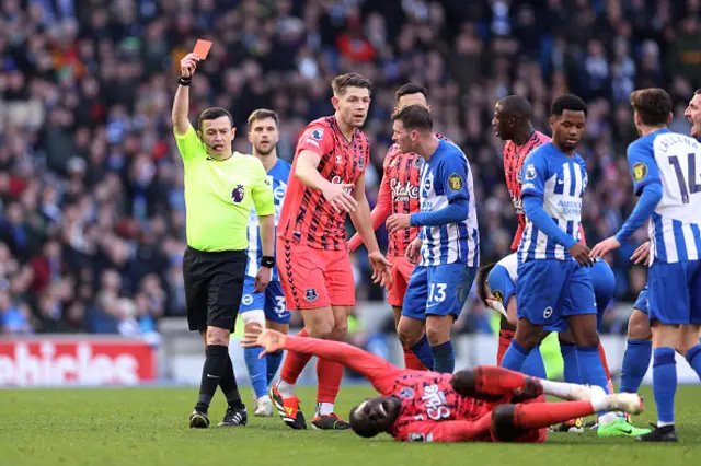 Referee Tony Harrington shows a red card to Billy Gilmour