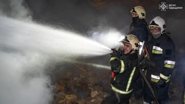 Firefighters work at a site of a residential building damaged by a Russian drone strike, amid Russia's attack on Ukraine, in Odesa