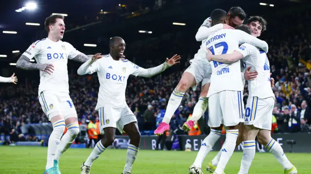 Leeds players celebrate a goal against Leicester