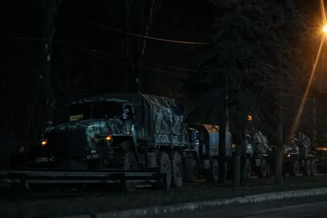 Russian military tanks and armoured vehicles advance in Donetsk under the cover of darkness on 24 February 2022