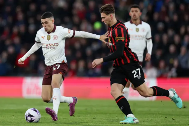 Phil Foden vies with defender Illia Zabarnyi
