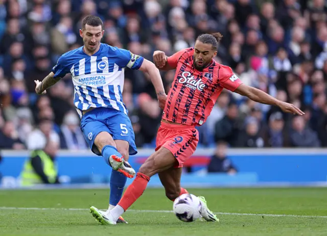 ewis Dunk of Brighton & Hove Albion passes the ball whilst under pressure from Dominic Calvert-Lewin