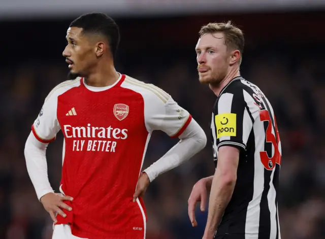 Sean Longstaff reacts alongside Arsenal's William Saliba