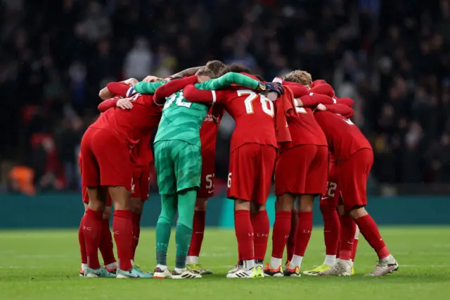 Players of Liverpool form a huddle ahead of the second half during the Carabao Cup Final