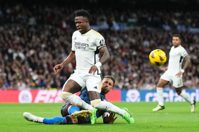 Vinicius Junior is challenged by Sergio Ramos