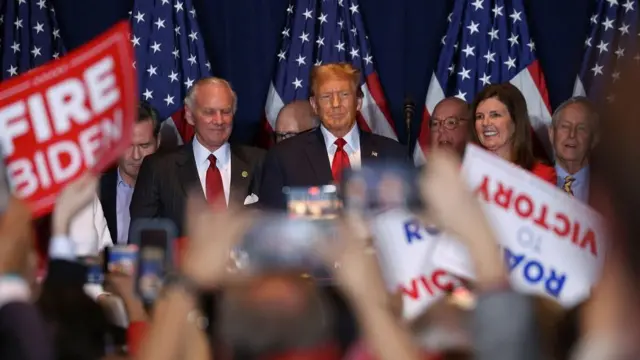 Republican presidential candidate and former U.S. President Donald Trump stands on stage as he hosts a South Carolina Republican presidential primary election night party in Columbia, South Carolina, U.S. February 24, 2024.