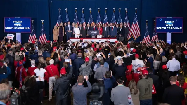 ormer US President Donald Trump, center, speaks during an election night watch party at the South Carolina State Fairgrounds in Columbia, South Carolina, US, on Saturday, Feb. 24, 2024. Trump won the Republican presidential primary in South Carolina, according to AP, delivering a blow to rival Nikki Haley in her home state as the former president continues his sweep of the 2024 nominating contests