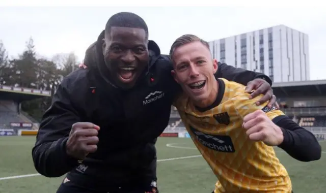 George Elokobi (left) celebrates a Maidstone United victory