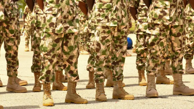 Nigerian soldiers stand in line