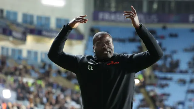 Maidstone boss George Elokobi gees up the away fans before their FA Cup tie at Coventry