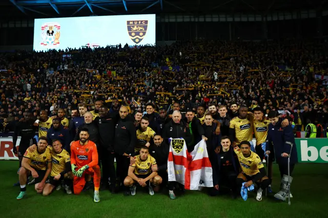 Maidstone's players pose in front of their fans after the FA Cup defeat at Coventry