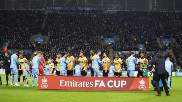 Coventry and Maidstone players shake hands before kick-off