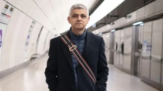 Sadiq Khan walking along the tube platform in central London