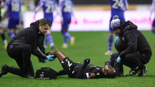 Carlos Mendes Gomes, of Bolton Wanderers, is treated for an injury