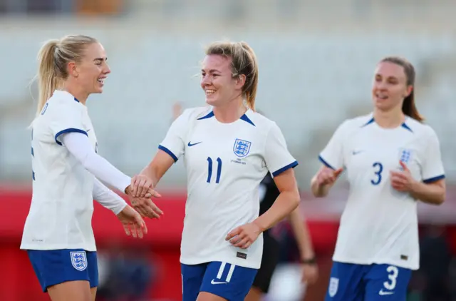 Lauren Hemp celebrates with Alex Greenwood and Niamh Charles