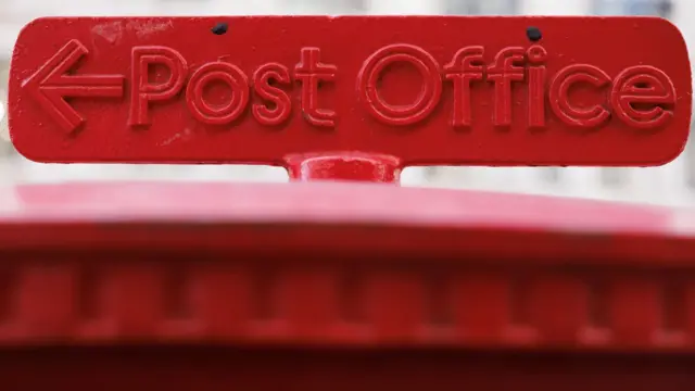 Red Post Office logo on top of a post box