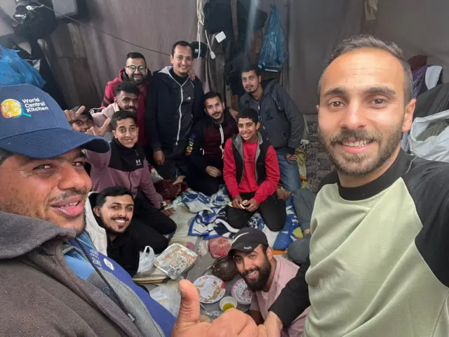 A group of men in a tent in Gaza sharing a meal