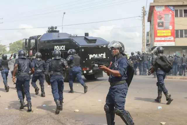 Benin riot officers disperse demonstrators gathered to protest against the current president's free-market reforms in Cotonou on March 9, 2018