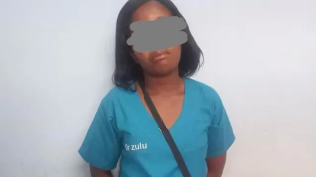 A woman wearing medical scrubs