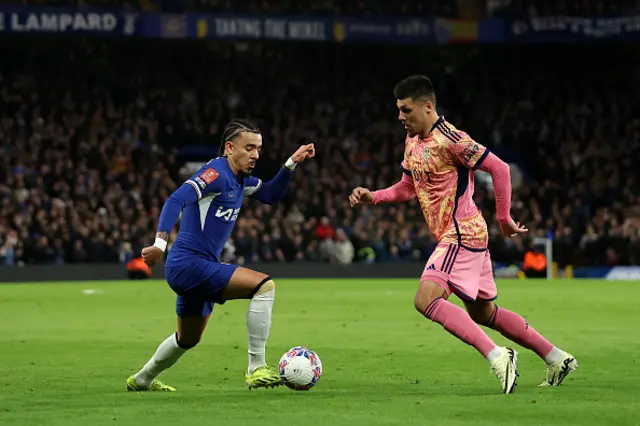 Malo Gusto of Chelsea runs with the ball whilst under pressure from Joel Piroe