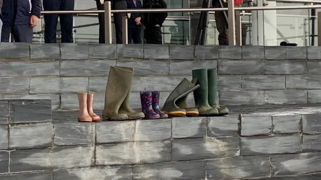 Different size wellies are lined up on the steps outside the Senedd