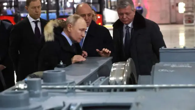 Russian President Vladimir Putin looks at electric train shassis