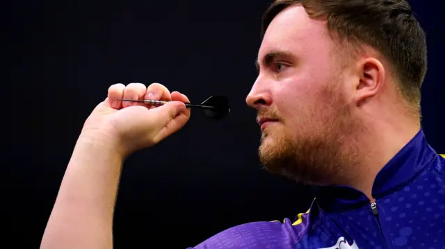 Luke Littler throws a dart