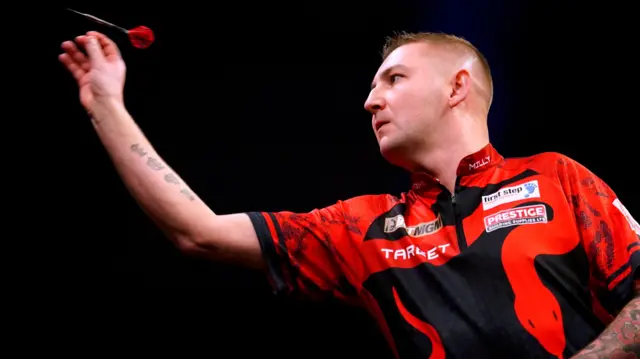 Nathan Aspinall throws a dart