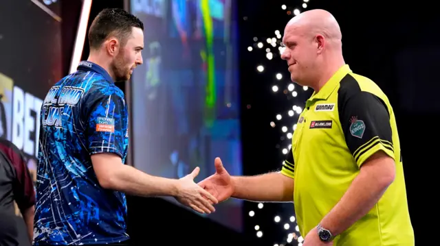 Luke Humphries and Michael van Gerwen shake hands