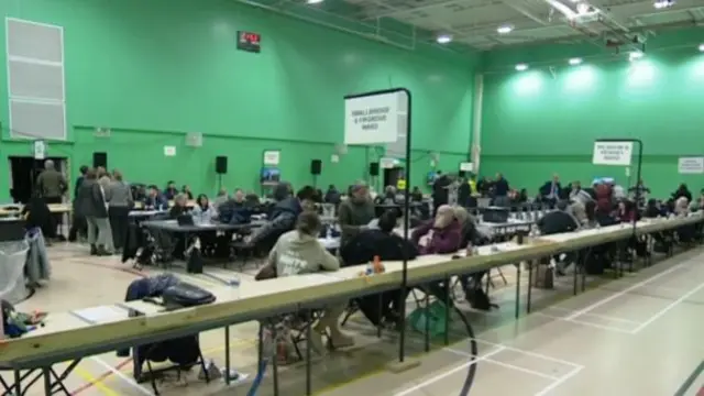 Votes are counted in a bright green hall in Rochdale