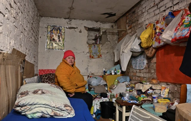 A local resident sits on a bed inside a shelter in Zaporizhzhia region, where Russia has intensified its strikes, 28 February