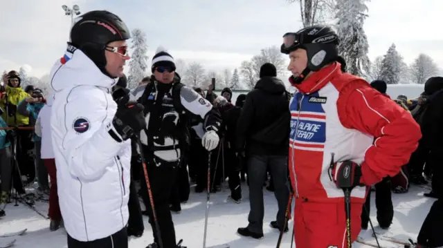 Former Russian President Dmitry Medvedev (L) and Vladimir Putin prepare to ski at the Rosa Khutor alpine ski resort in Krasnaya Polyana, on March 8, 2012.