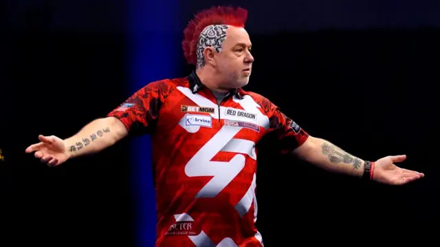 Peter Wright walks onto the stage