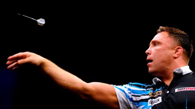 Gerwyn Price throws a dart