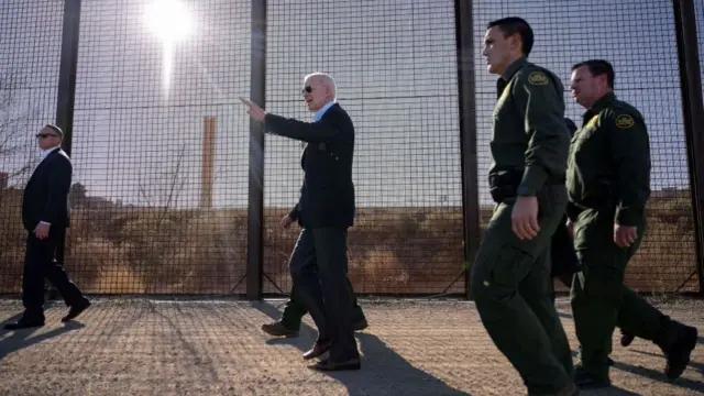 US President Joe Biden walks along the US-Mexico border fence in El Paso, Texas, on January 8, 2023. - Biden went to the US-Mexico border on Sunday for the first time since taking office, visiting an El Paso, Texas entry point at the center of debates over illegal immigration and smuggling.