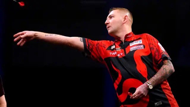 Nathan Aspinall throws a dart