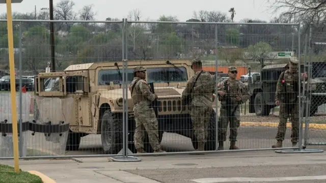 Members of the U.S. National Guard stand guard at the gate of Shelby Park where former President Trump will have a border visit event in Eagle Pass, Texas, U.S., February 28, 2024.