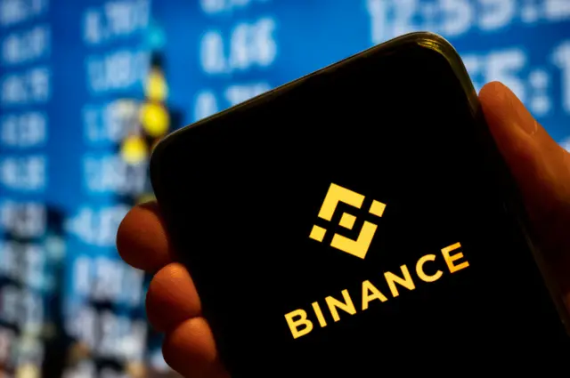 In this photo illustration, the cryptocurrency exchange trading platform Binance logo is displayed on a smartphone screen.