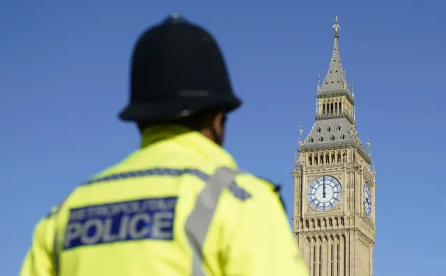 Police officer stands in front of Big Ben