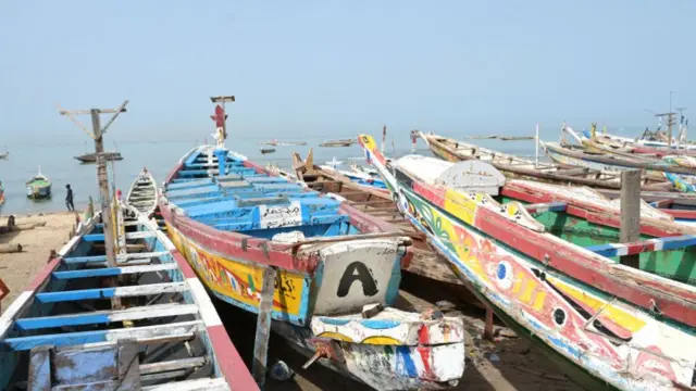 Pirogues are seen on the beach at the fishing quay in Mbour, Senegal - July 2023